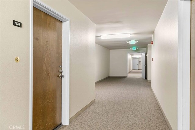 hallway featuring light carpet