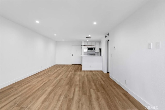 unfurnished living room with light wood-type flooring