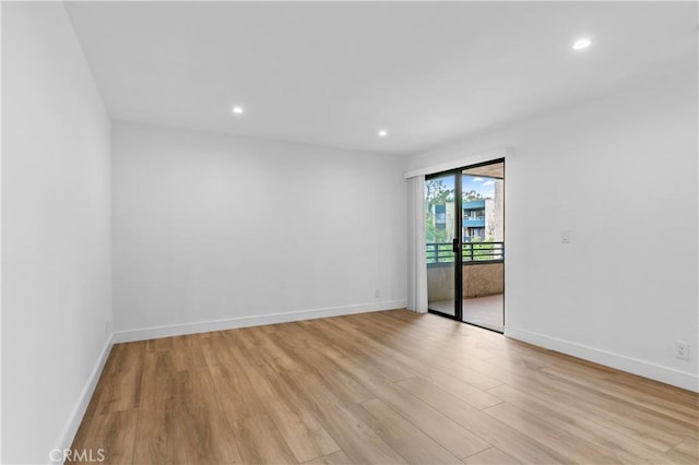 unfurnished room with light hardwood / wood-style flooring