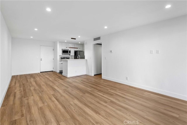 unfurnished living room with light wood-type flooring