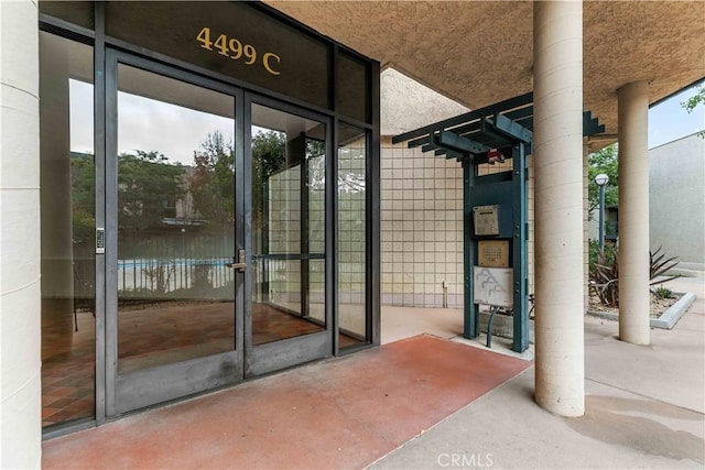 view of exterior entry featuring french doors