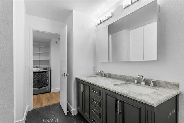 bathroom with washer / dryer and vanity