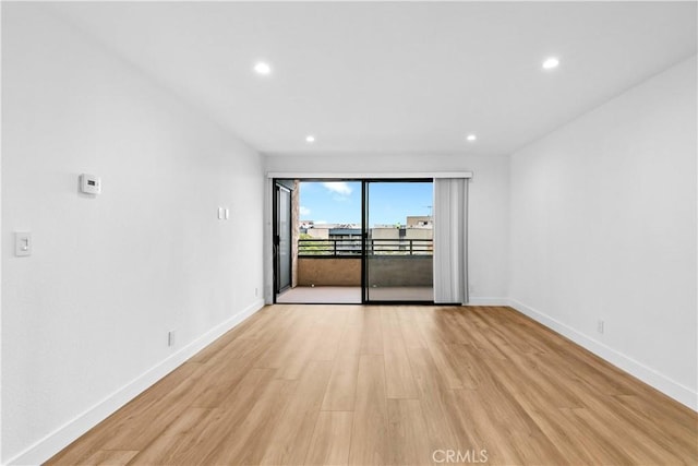 spare room with light hardwood / wood-style flooring