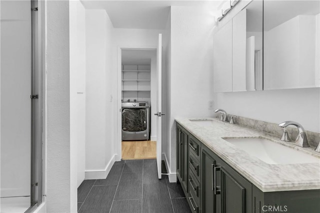 bathroom featuring washer / clothes dryer and vanity