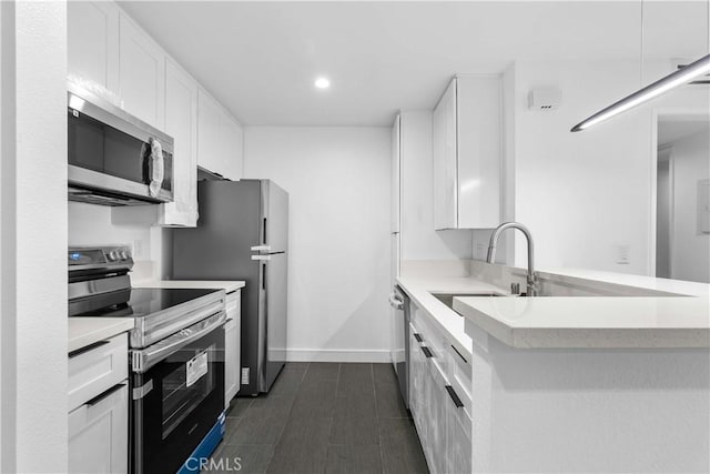 kitchen with white cabinets, appliances with stainless steel finishes, and sink