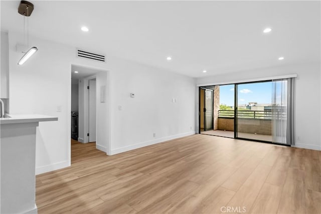 unfurnished living room featuring light wood-type flooring