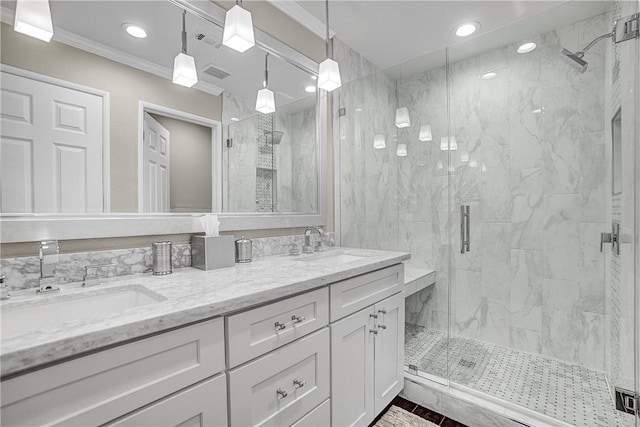 full bath with a sink, double vanity, a stall shower, and ornamental molding