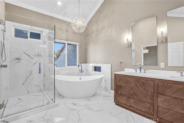 bathroom featuring marble finish floor, a sink, a marble finish shower, crown molding, and a freestanding bath