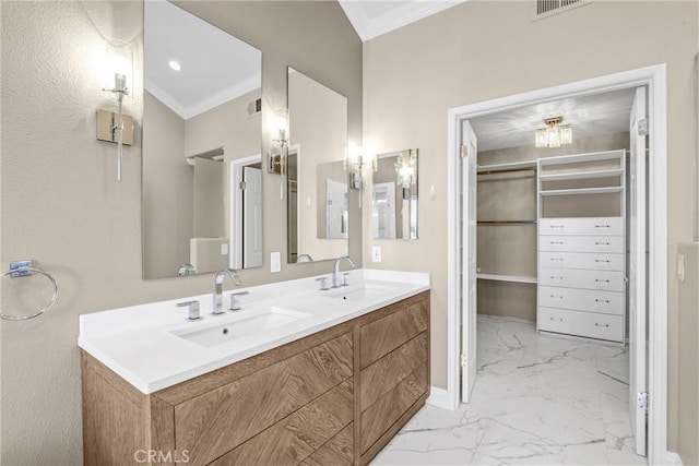 bathroom with ornamental molding, visible vents, marble finish floor, and a sink