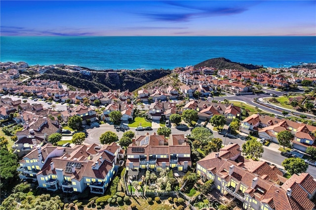 aerial view at dusk with a residential view and a water view