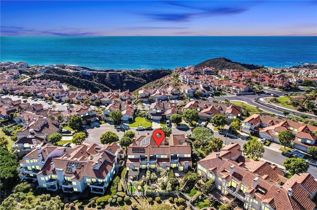 aerial view at dusk featuring a residential view and a water view