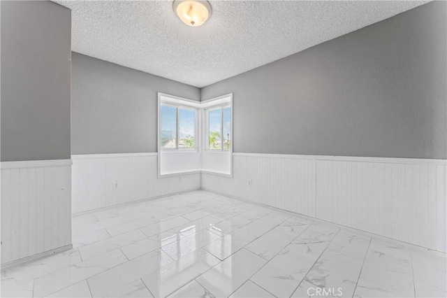 spare room featuring a textured ceiling