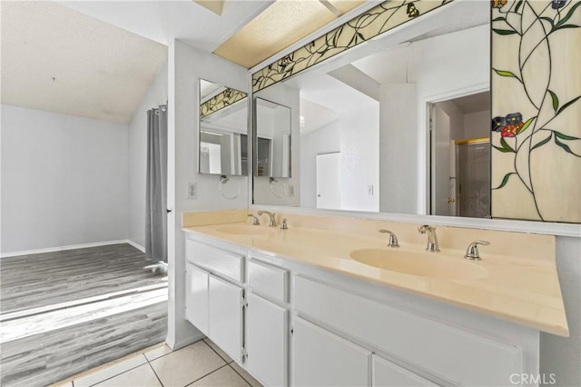 bathroom with vanity, a shower with door, and tile patterned floors