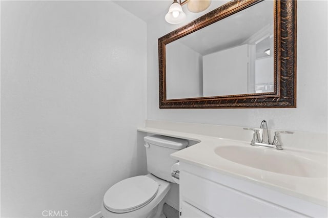 bathroom featuring toilet and vanity