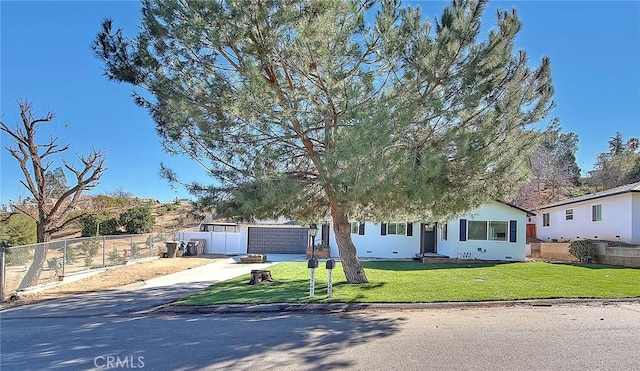 obstructed view of property with a front lawn and a garage