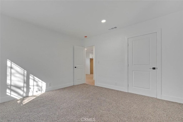 spare room featuring light colored carpet