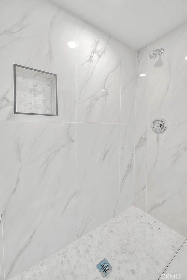 bathroom with a tile shower