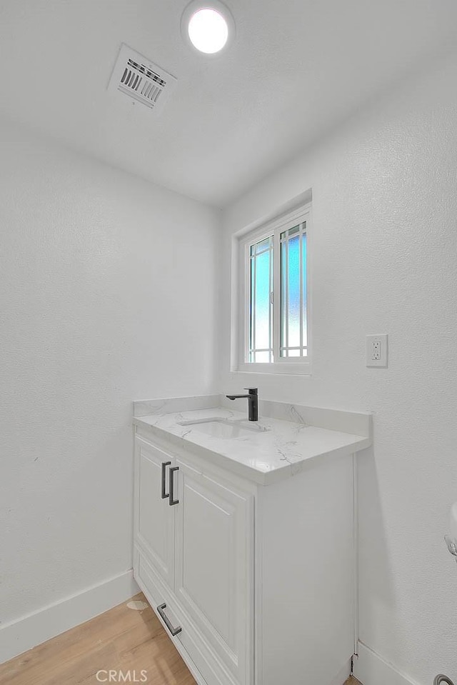 bathroom with vanity and hardwood / wood-style floors