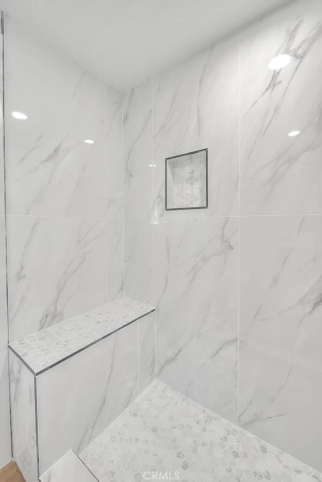 bathroom with a tile shower