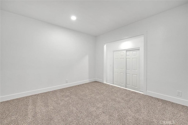 unfurnished bedroom featuring carpet floors and a closet