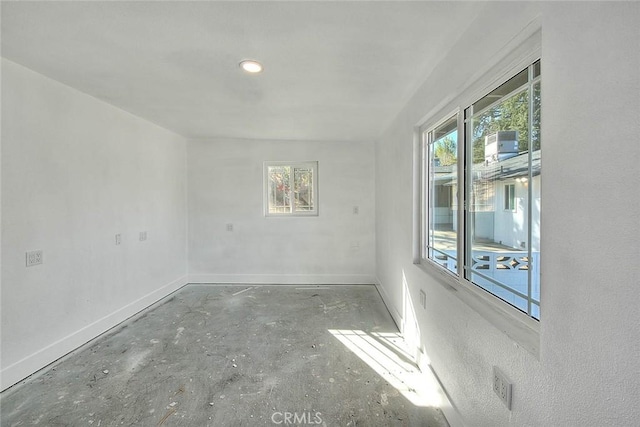 unfurnished room with concrete floors and a wealth of natural light