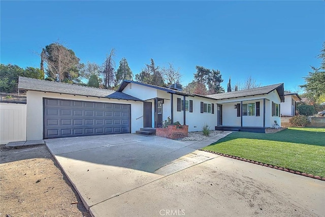 ranch-style home featuring a garage and a front lawn