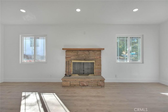 unfurnished living room with light hardwood / wood-style floors and a fireplace