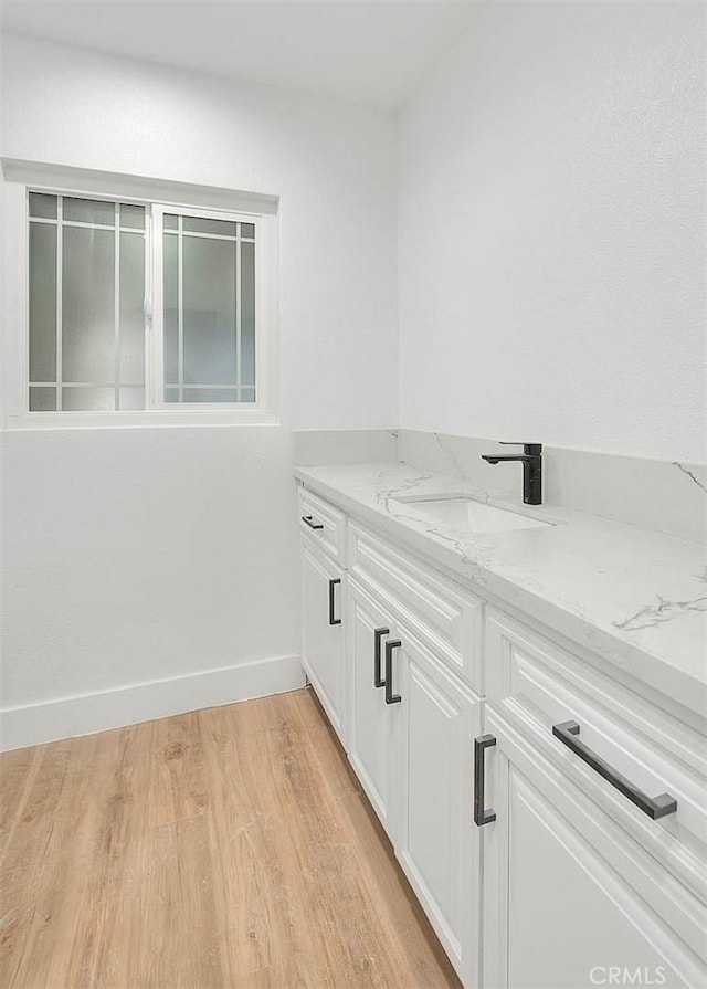 bathroom with hardwood / wood-style flooring and vanity