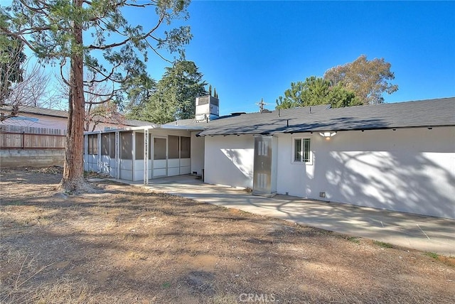 back of house with a patio and a sunroom