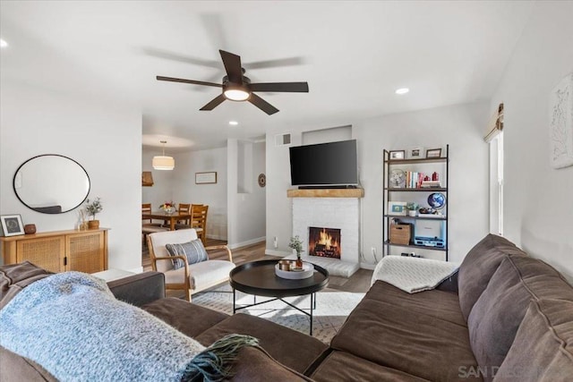 living room featuring ceiling fan and hardwood / wood-style floors