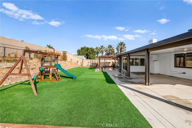 view of yard featuring a playground and a patio