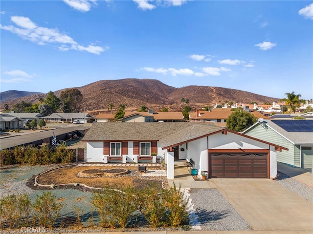 ranch-style house featuring a mountain view and a garage