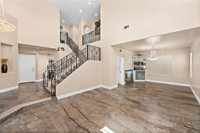 unfurnished living room with a towering ceiling