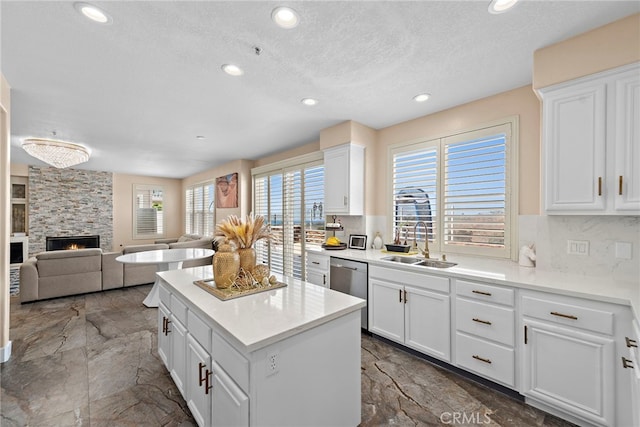 2438 Calle Aquamarina, San Clemente, CA 92673 - kitchen featuring a sink, dishwasher, recessed lighting, tasteful backsplash, and a fireplace