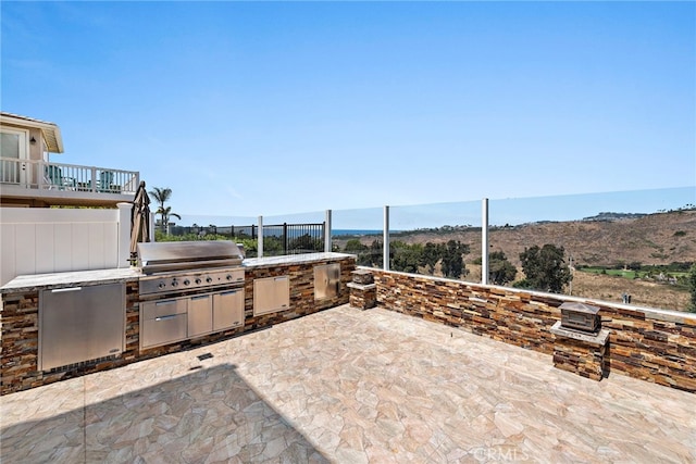 view of patio / terrace featuring area for grilling, a mountain view, and grilling area