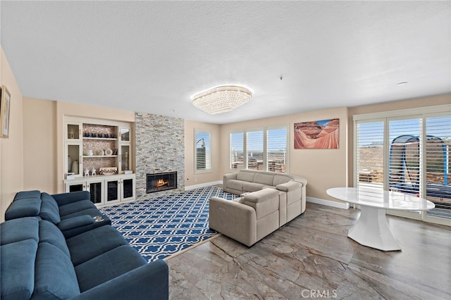 2438 Calle Aquamarina, San Clemente, CA 92673 - living room featuring baseboards, a fireplace, a textured ceiling, and built in shelves