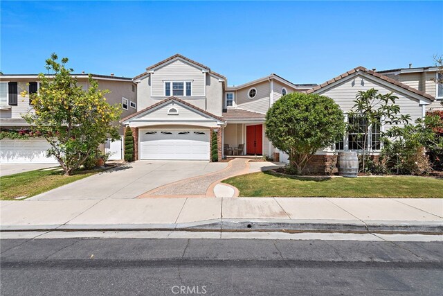 2438 Calle Aquamarina, San Clemente, CA 92673 - view of front of property with driveway, a front yard, a tile roof, an attached garage, and solar panels