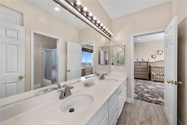 bathroom with vanity, a shower with shower door, and wood-type flooring