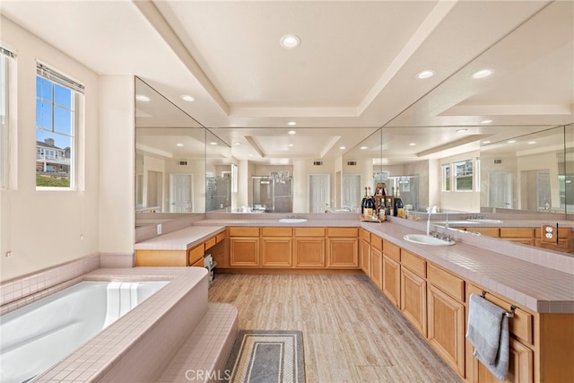 2438 Calle Aquamarina, San Clemente, CA 92673 - bathroom featuring a garden tub, double vanity, plenty of natural light, recessed lighting, and a raised ceiling