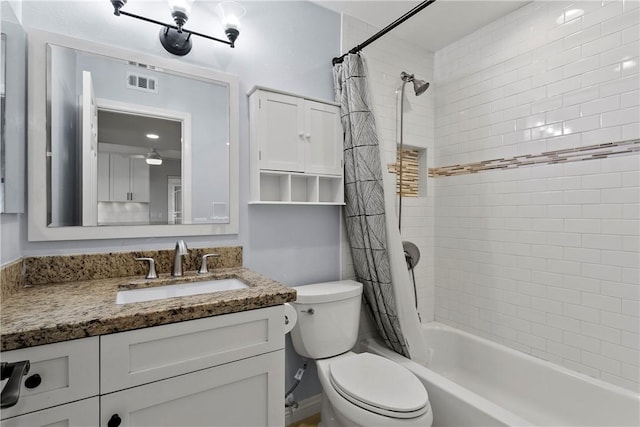 full bathroom with shower / bath combo with shower curtain, toilet, and vanity