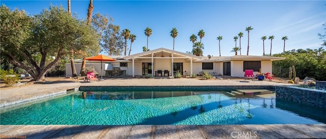 view of swimming pool with a patio