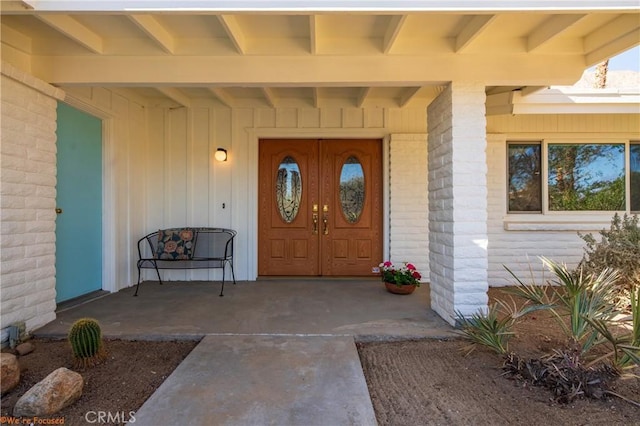 view of exterior entry with covered porch