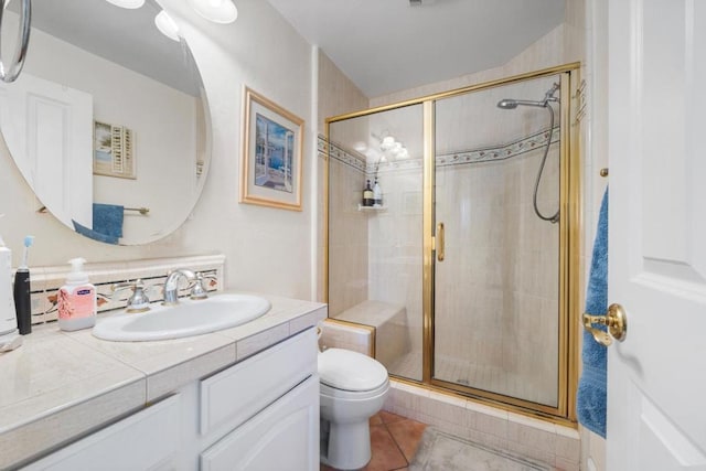 bathroom featuring an enclosed shower, vanity, tile patterned flooring, and toilet