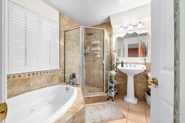 bathroom with separate shower and tub and tile patterned floors