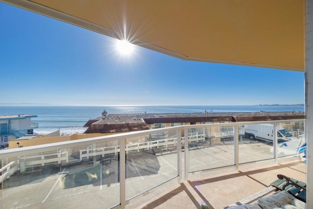 balcony with a view of the beach and a water view