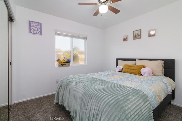 bedroom with ceiling fan and dark colored carpet