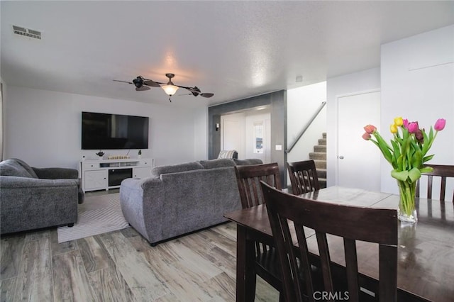 living room with hardwood / wood-style flooring and ceiling fan