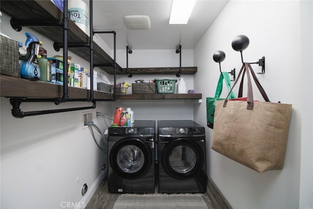 laundry area with separate washer and dryer and hardwood / wood-style floors