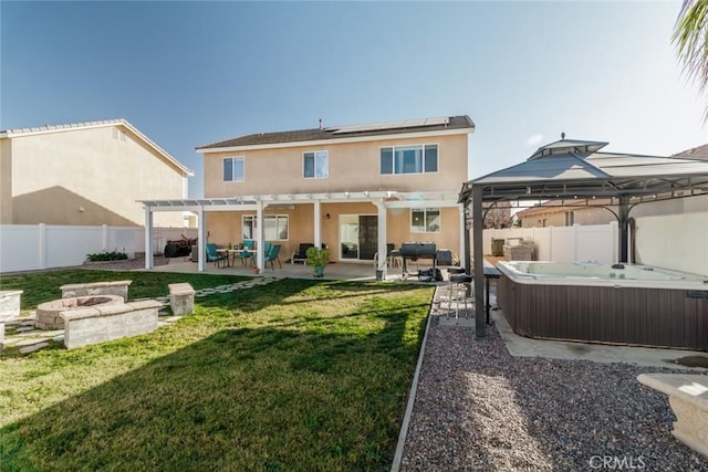 rear view of house featuring a pergola, a fire pit, a patio, a hot tub, and a gazebo