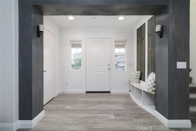 mudroom featuring beam ceiling and light hardwood / wood-style floors